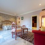 Vista del dormitorio principal con papel decorativo floral y acceso a vestidor en propiedad de La Costa del Sol